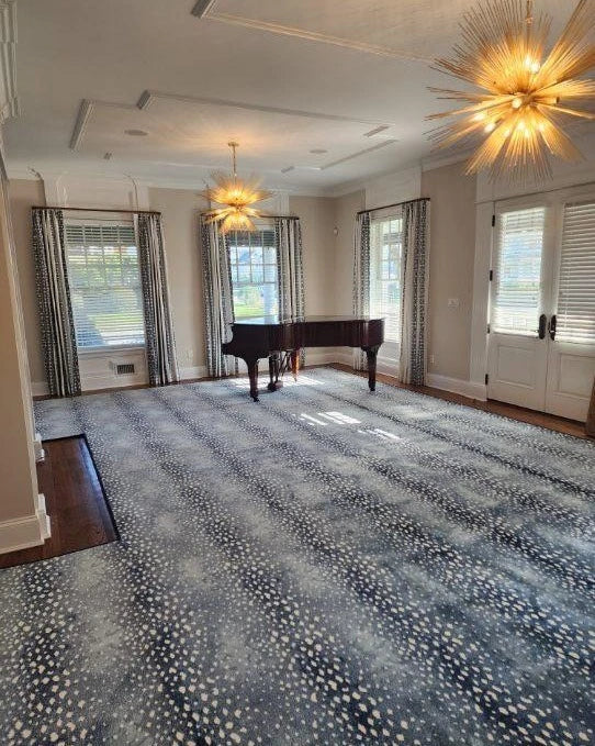 Custom light neutral area rug in a luxury bedroom suite with modern furnishings.