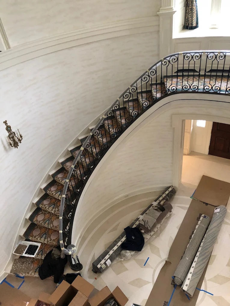 Custom patterned stair runner fitted to a curved staircase.