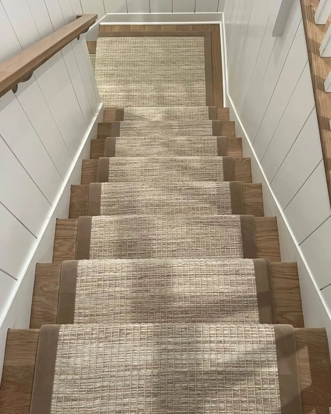 Custom stair runner professionally installed on a hardwood staircase in Little Silver, NJ.