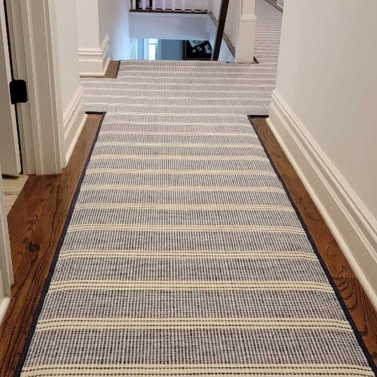 Custom stair runner installed on a hallway and staircase in a luxury Monmouth County, NJ home by Weinstein by STARK