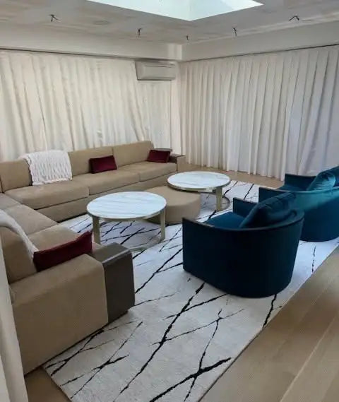 Large custom area rug with a contemporary marble-inspired pattern in a luxury home.