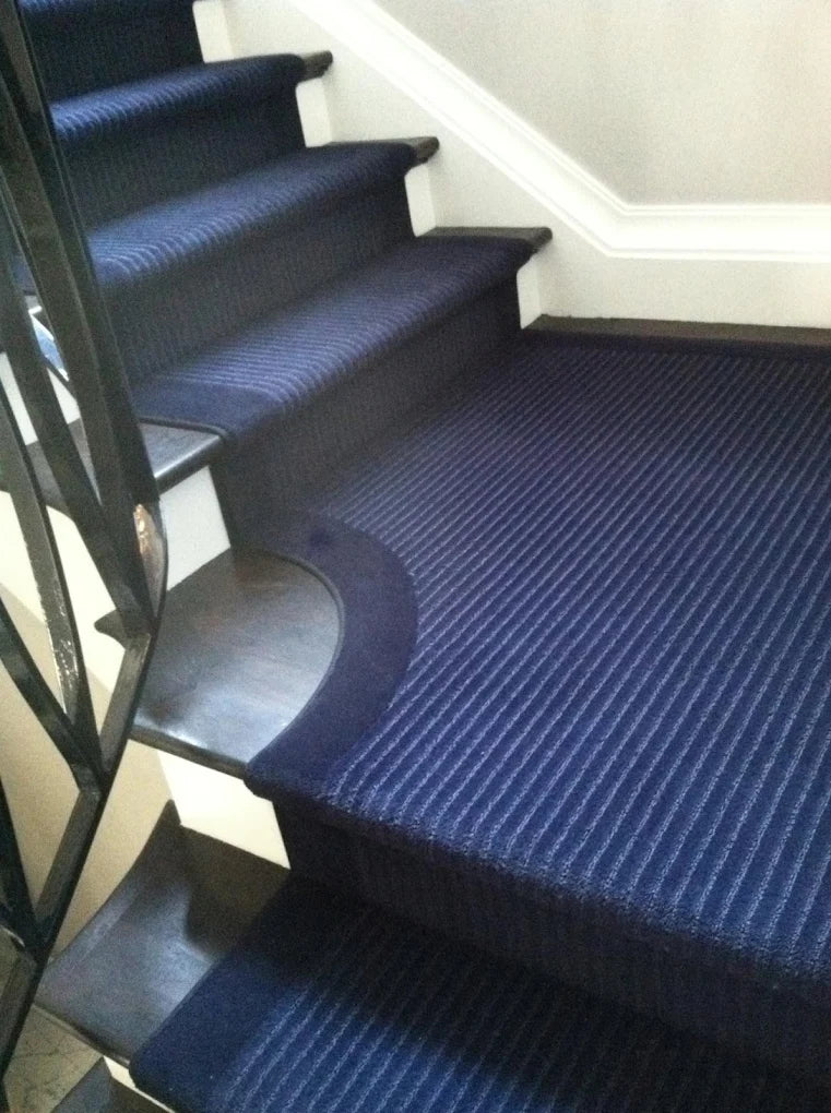 Navy blue custom stair runner installed on a staircase.