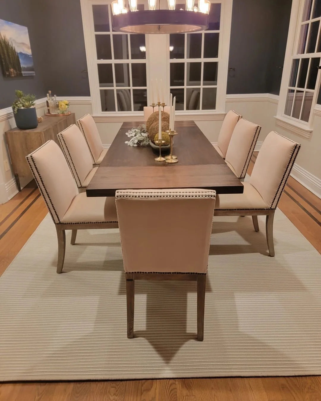 Neutral custom area rug beneath a dining table creating a balanced dining space.